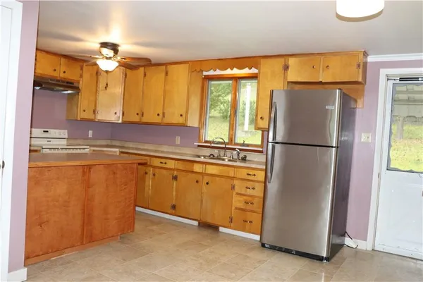 a kitchen with stainless steel appliances granite countertop a refrigerator a sink and dishwasher