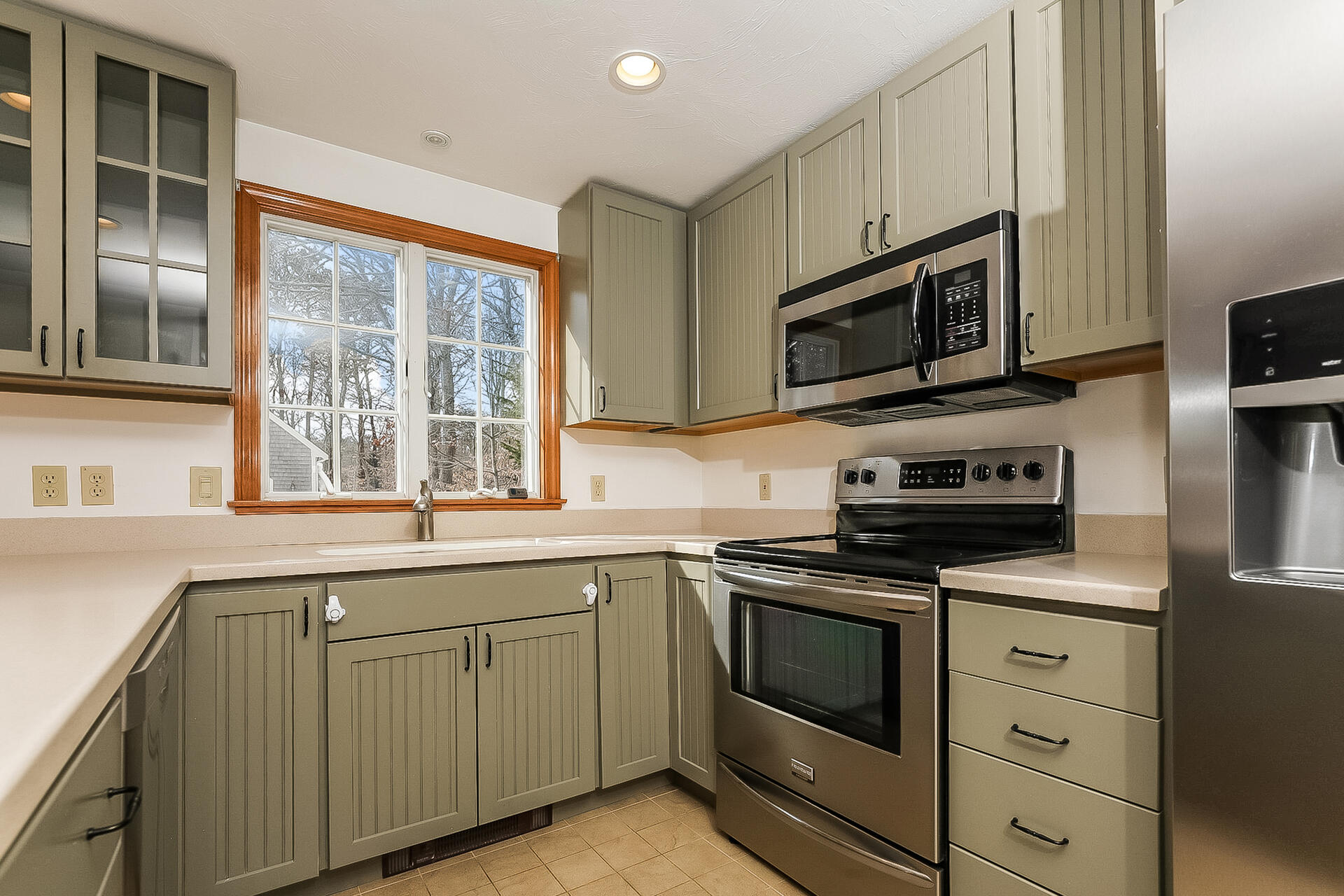 34 Marlboro Road Brewster, MA 02631 - Photo 5 of 23 a kitchen with stainless steel appliances granite countertop white cabinets a sink and a stove