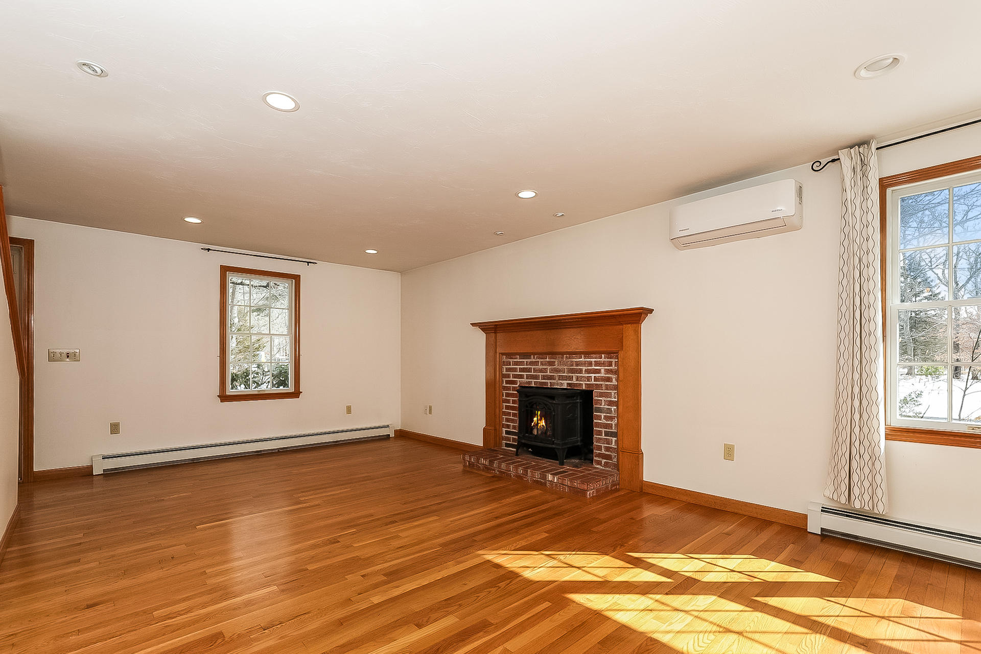 34 Marlboro Road Brewster, MA 02631 - Photo 10 of 23 an empty room with windows and fireplace