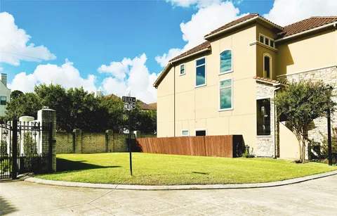 a view of a white house with a yard