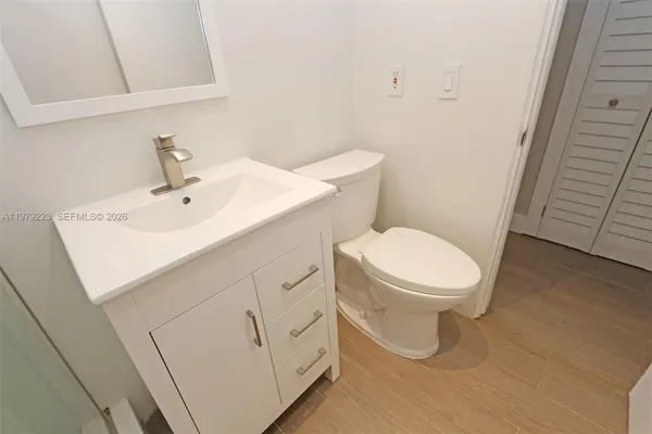 a white toilet sitting next to a white sink