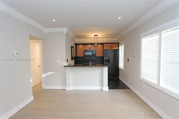 a view of a kitchen with a sink and dishwasher cabinets
