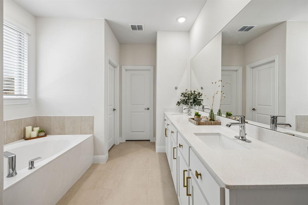 425 Breeds Hl Road Little Elm, TX 75068 - Photo 14 of 38 a bathroom with a tub sink and mirror