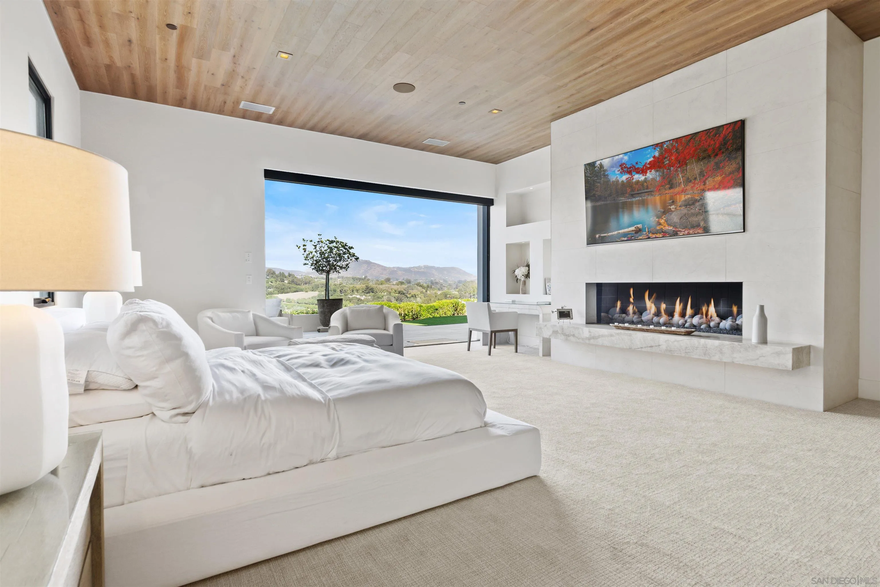 5516 La Crescenta Road Rancho Santa Fe, CA 92067 - Photo 18 of 49 a spacious bedroom with a bed and a couch