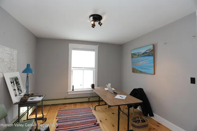 a view of entryway with paintings on the wall