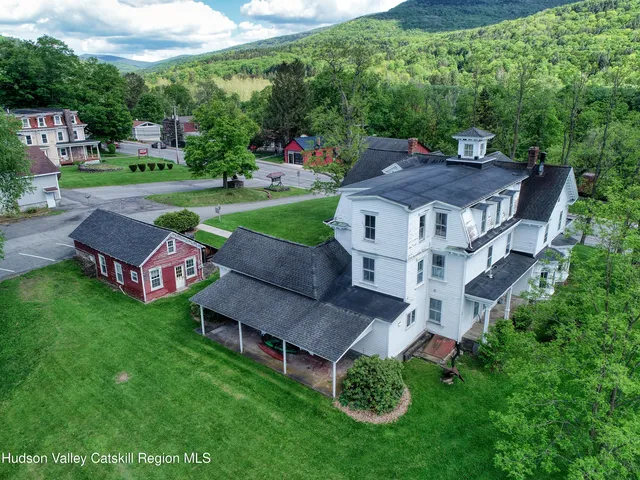 an aerial view of a house with garden space and street view