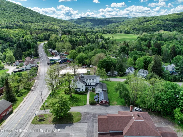 an aerial view of a house with yard