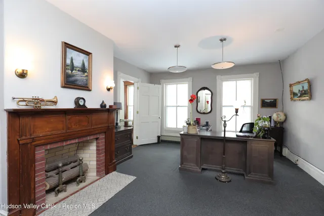 a living room with furniture a window and a fireplace