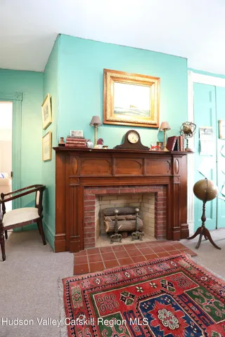a living room with furniture a fireplace and a window