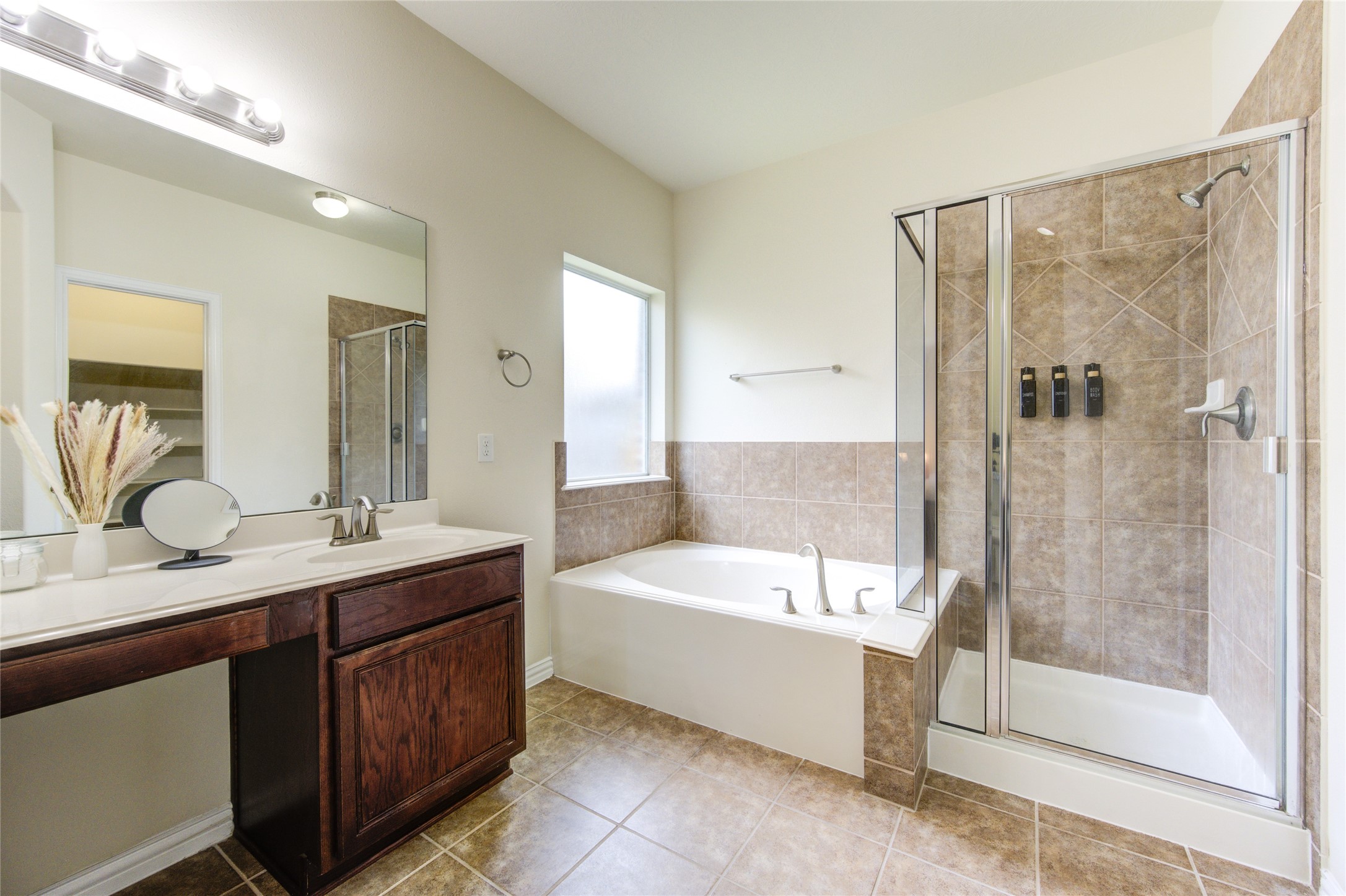 4211 Tristan Ridge Lane Katy, TX 77449 - Photo 19 of 31 a bathroom with a tub a sink and a shower