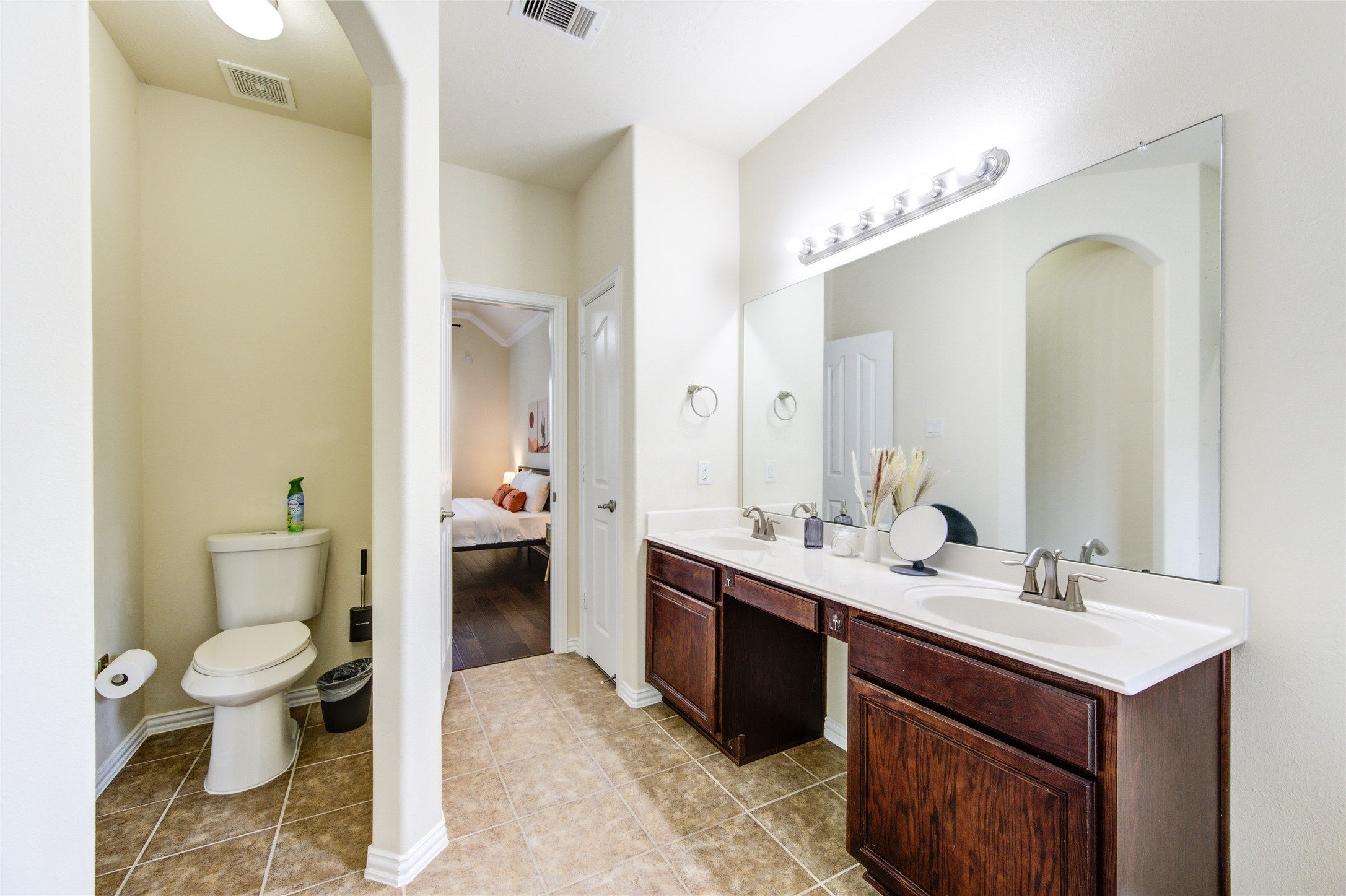 4211 Tristan Ridge Lane Katy, TX 77449 - Photo 20 of 31 a spacious bathroom with a double vanity sink toilet and a mirror