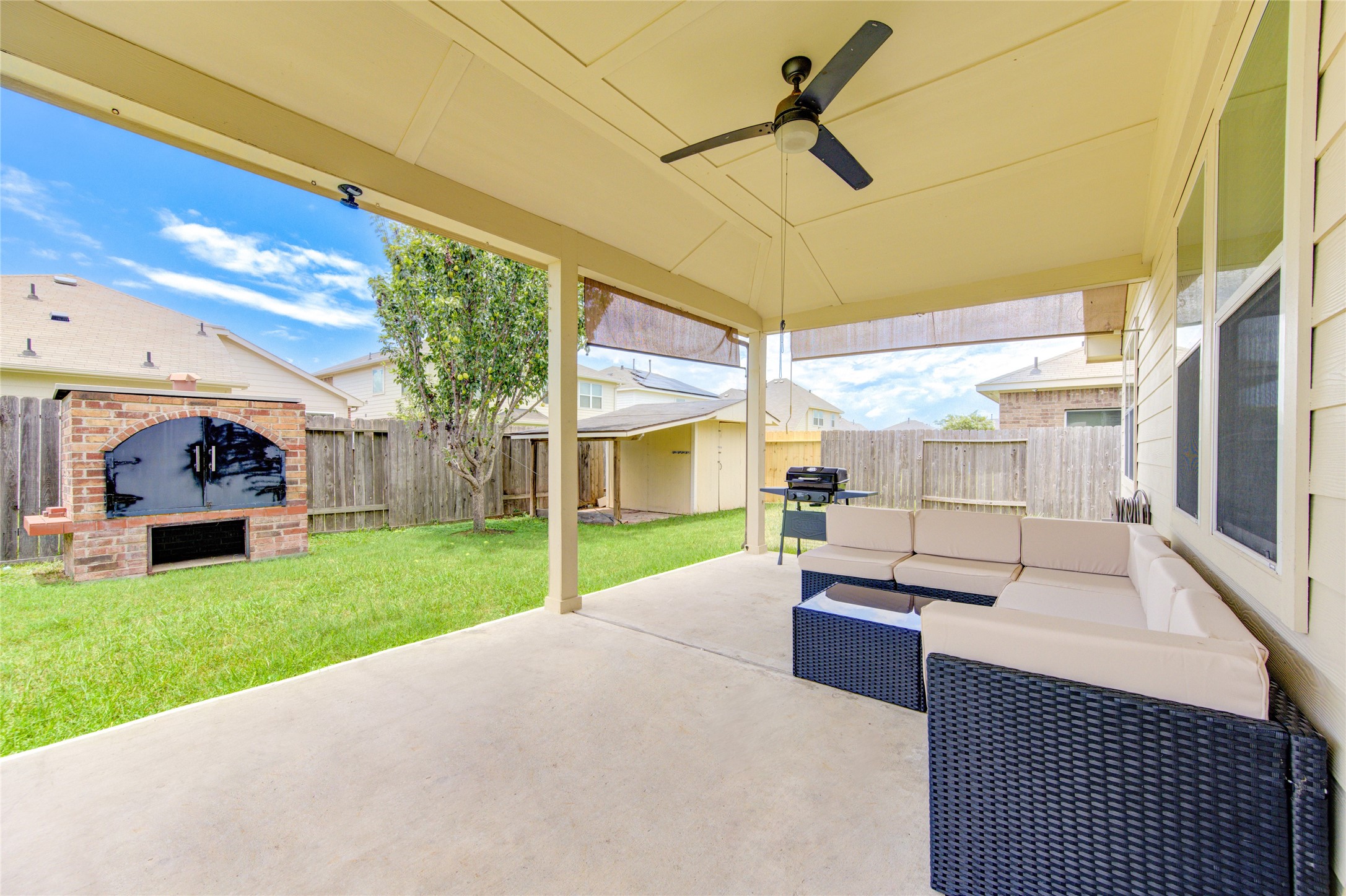 4211 Tristan Ridge Lane Katy, TX 77449 - Photo 28 of 31 a view of a backyard with couches plants and large trees