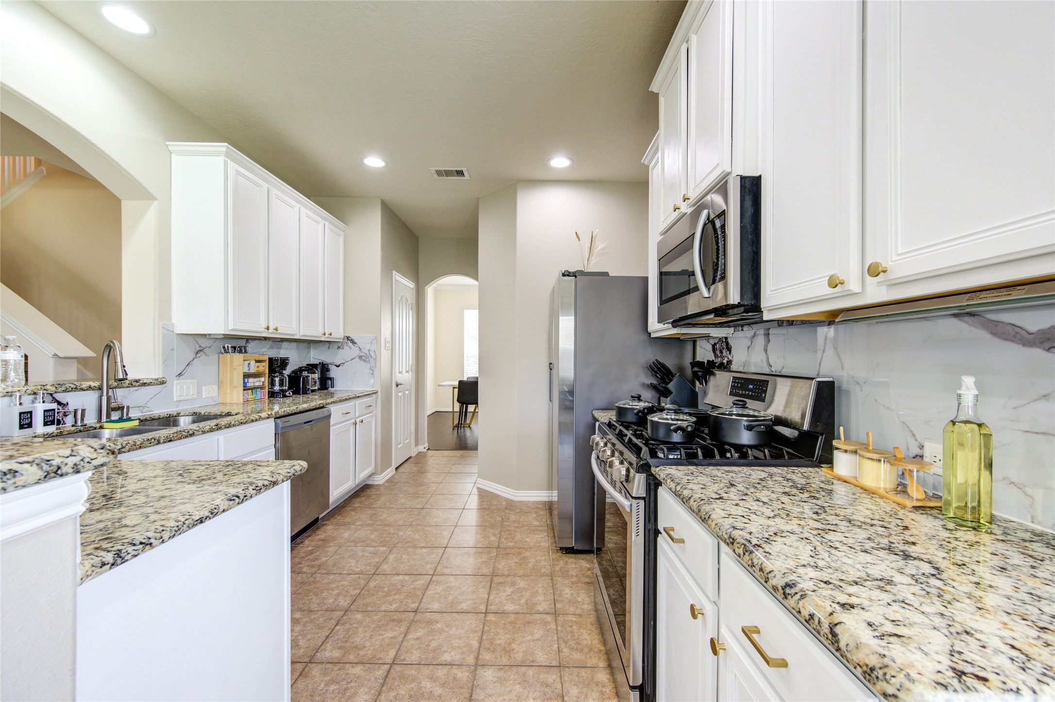 4211 Tristan Ridge Lane Katy, TX 77449 - Photo 8 of 31 a kitchen with stainless steel appliances granite countertop a sink stove and refrigerator