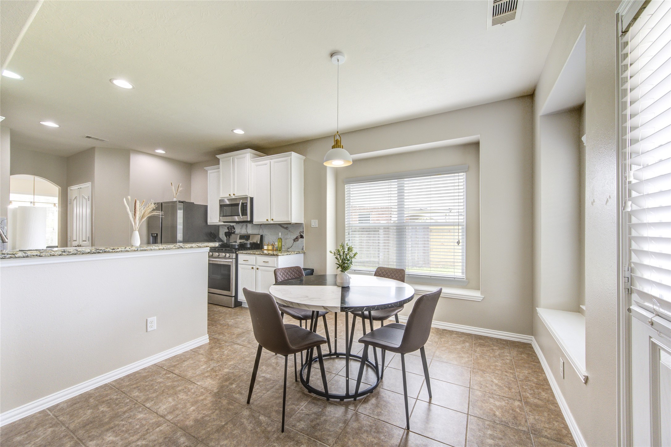 4211 Tristan Ridge Lane Katy, TX 77449 - Photo 10 of 31 a view of a dining room with furniture and window
