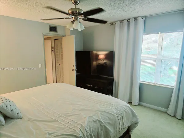 a bedroom with a bed and a flat tv screen