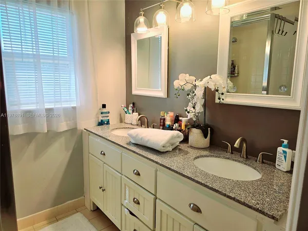 a bathroom with sink granite and mirror