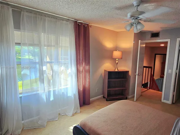 a bedroom with a bed and a mirror