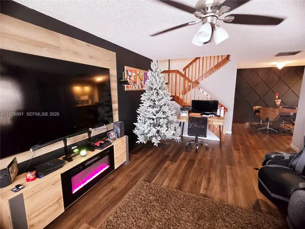 a living room with furniture and flat screen tv