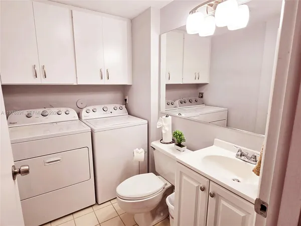 a bathroom with a sink toilet vanity and tub