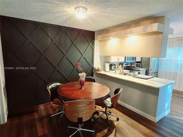 a kitchen with a table and chairs in it