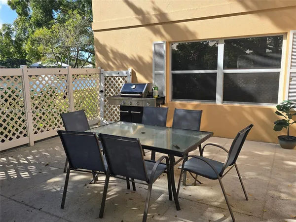 a view of an outdoor space with a table and chairs