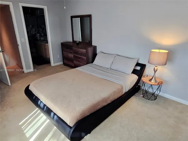 a bedroom with a bed and a dresser