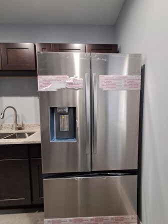 935 West Marquette Road, Unit 9371 Chicago, IL 60621 - Photo 11 of 25 a kitchen with metallic refrigerator and sink
