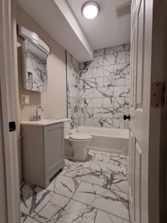 935 West Marquette Road, Unit 9371 Chicago, IL 60621 - Photo 20 of 25 a bathroom with a sink toilet and shower