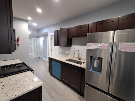 935 West Marquette Road, Unit 9371 Chicago, IL 60621 - Photo 10 of 25 a kitchen with stainless steel appliances a refrigerator and a stove