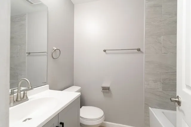 a bathroom with a sink toilet and shower