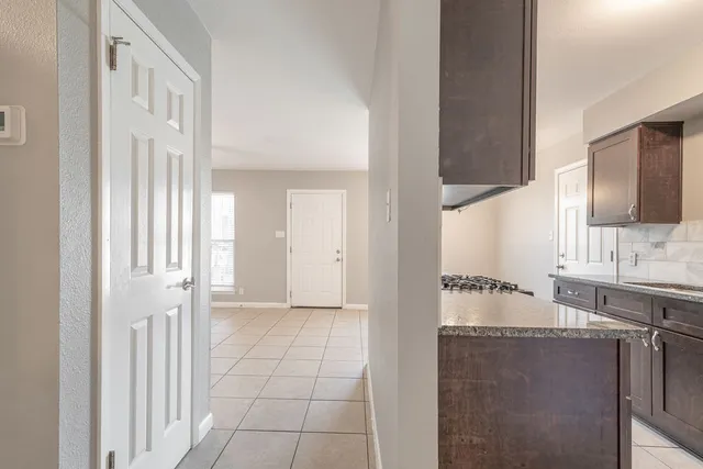 a view of a kitchen with a sink and cabinets