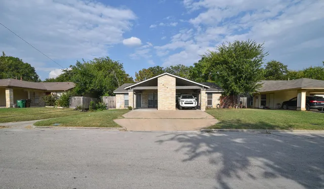 a house with huge green field in front of it