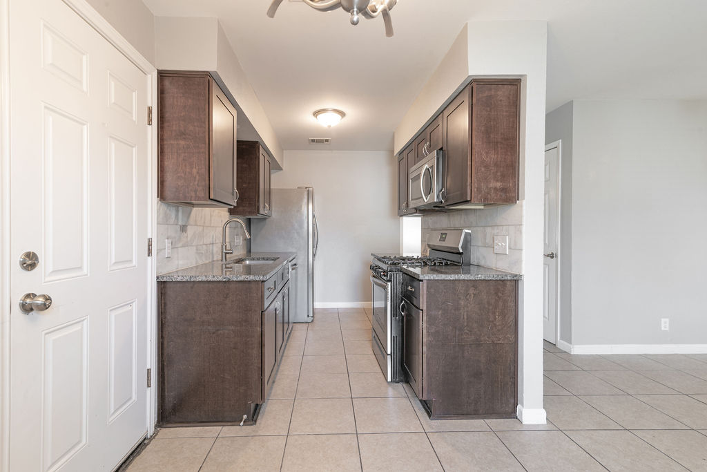 1810 Nicole Circle, Unit B Round Rock, TX 78664 - Photo 9 of 30 a kitchen with stainless steel appliances granite countertop a refrigerator and a sink