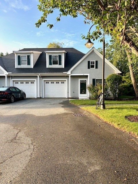 52 County Road, Unit 8 Mattapoisett, MA 02739 - Photo 1 of 19 a front view of a house with a yard