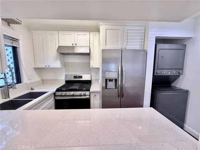 a bathroom with a granite countertop sink toilet and mirror