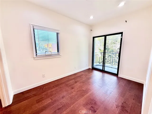 an empty room with wooden floor and closet