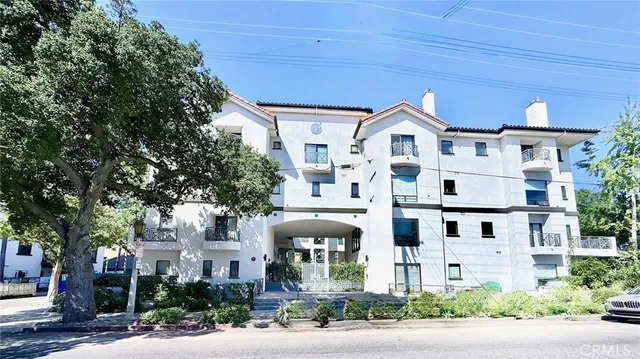 a front view of white house with a yard