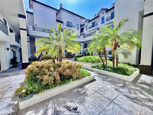 a view of a patio with couches table and chairs and potted plants