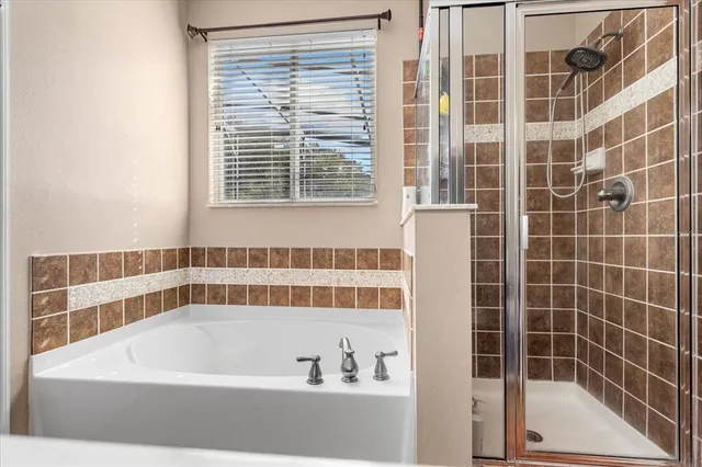 a bathroom with a bathtub and a shower
