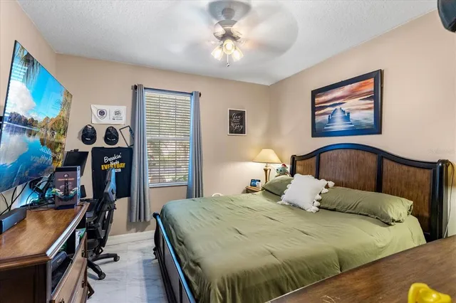 a bedroom with a bed and a painting on the wall