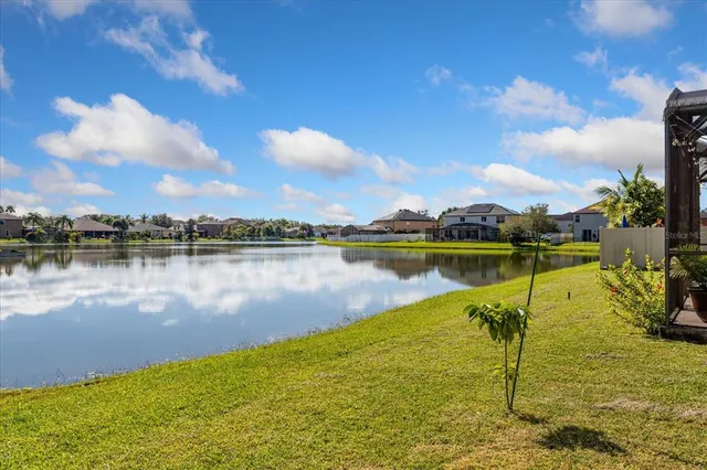 a view of a lake with houses in the back