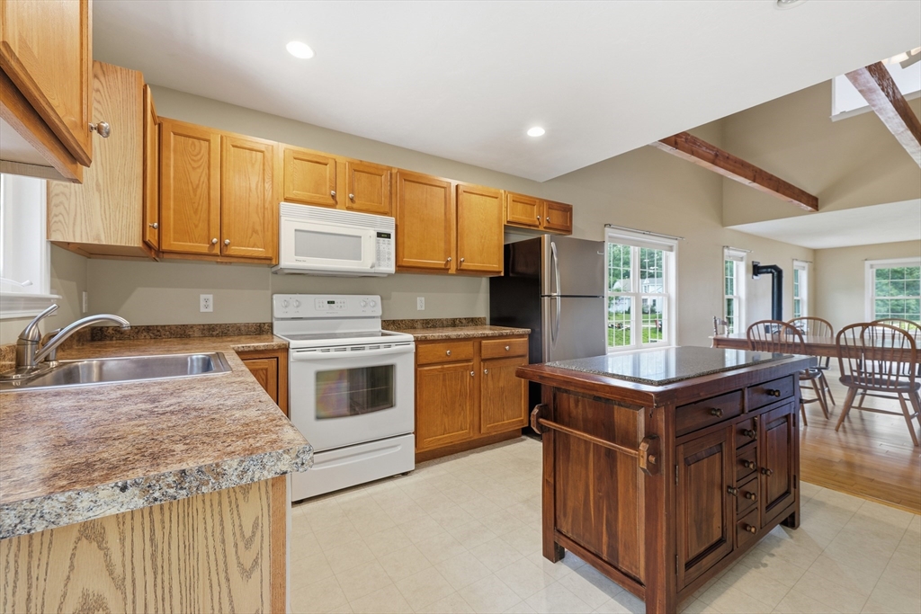 9 Rock Marsh Road, Unit B Wareham, MA 02571 - Photo 16 of 41 a kitchen with stainless steel appliances granite countertop a stove top oven a sink dishwasher and a refrigerator
