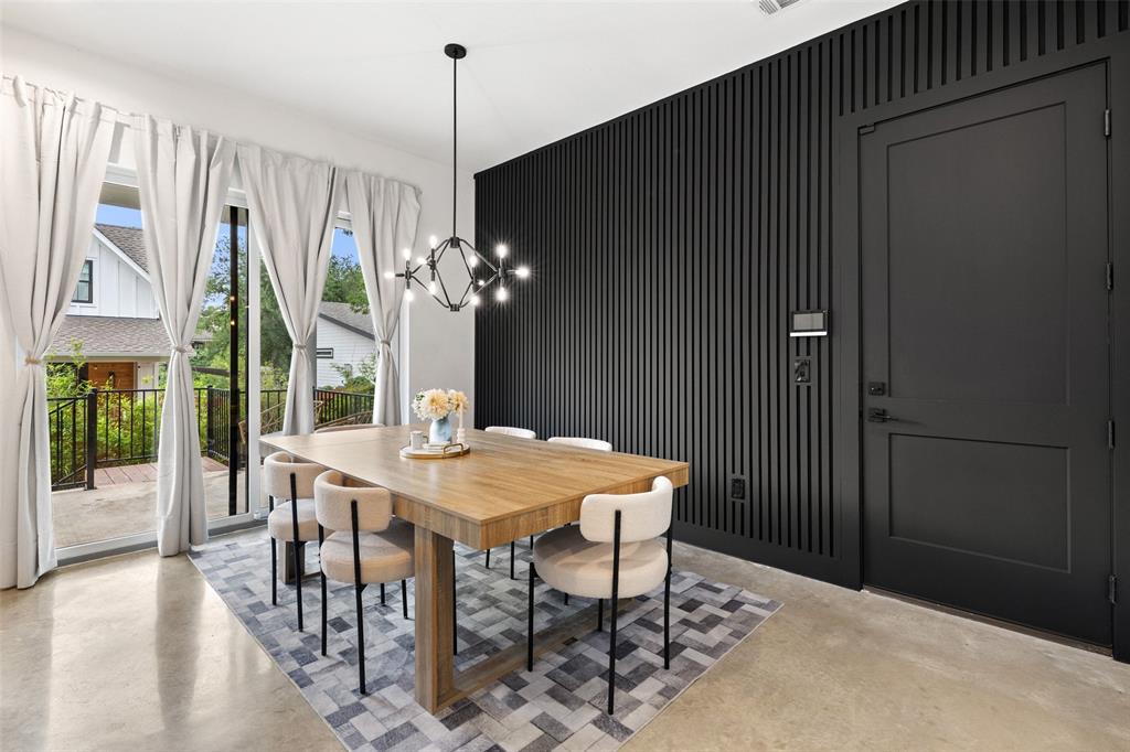 5007 Lott Avenue, Unit 1 Austin, TX 78721 - Photo 9 of 24 A striking black accent wall adds depth to this well-lit dining space with polished concrete floors.