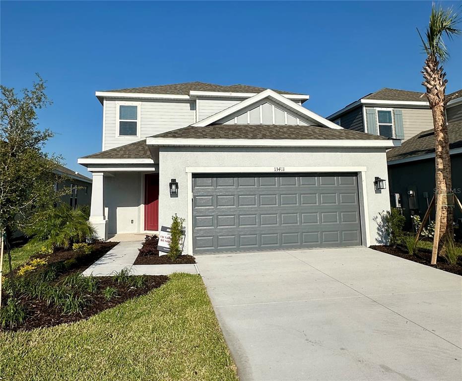 13411 Commons Avenue Parrish, FL 34219 - Photo 1 of 1 a front view of a house with a yard and garage