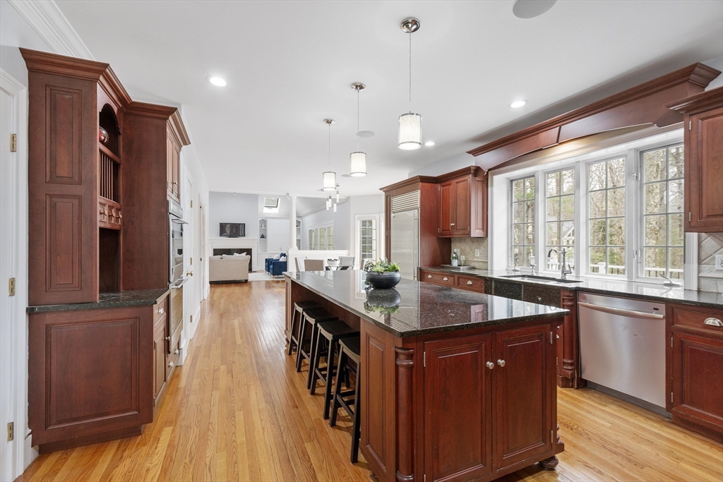 58 Buttrick Lane Carlisle, MA 01741 - Photo 13 of 39 a kitchen with stainless steel appliances granite countertop a sink stove and refrigerator