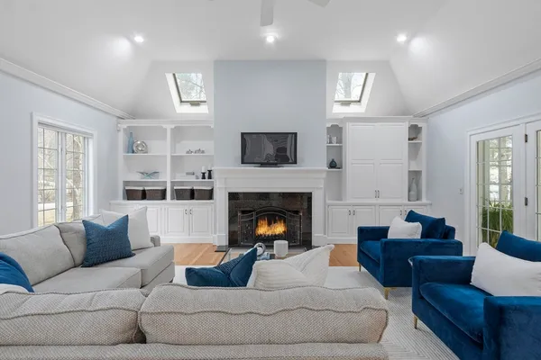 a living room with furniture and a floor to ceiling window