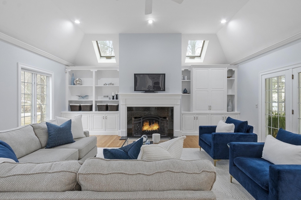 58 Buttrick Lane Carlisle, MA 01741 - Photo 15 of 39 a living room with furniture and a fireplace