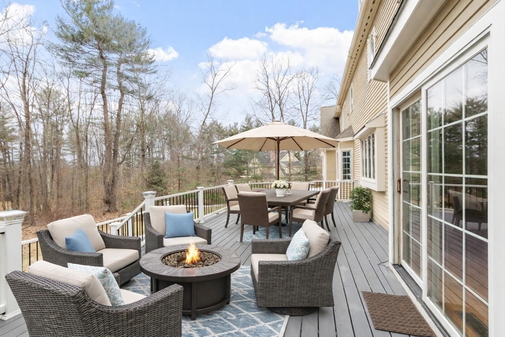 58 Buttrick Lane Carlisle, MA 01741 - Photo 20 of 39 a outdoor space with patio the couches and a potted plant on the table