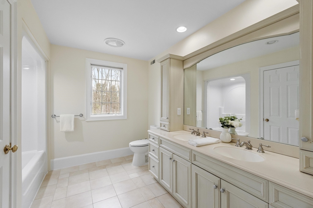 58 Buttrick Lane Carlisle, MA 01741 - Photo 28 of 39 a spacious bathroom with a double vanity sink mirror and toilet