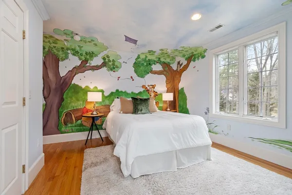 a living room with furniture a rug and kitchen view